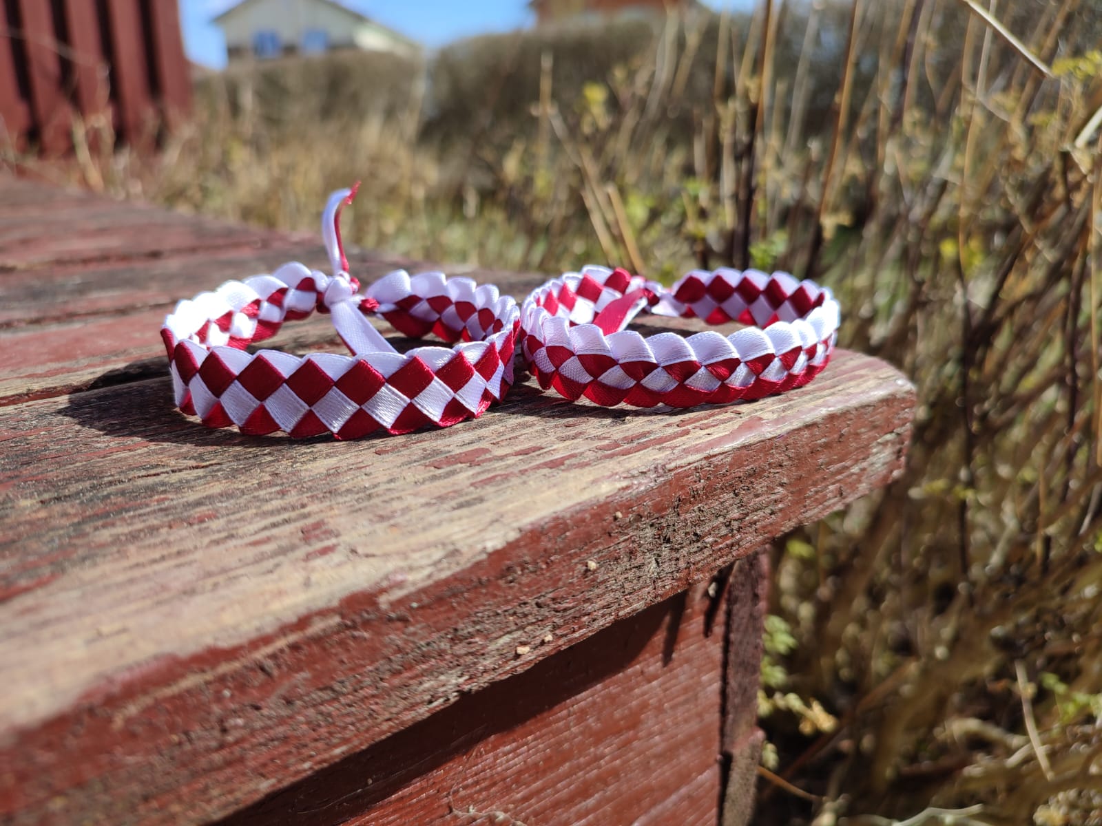 Friendship bracelets in the colours of the Latvian flag